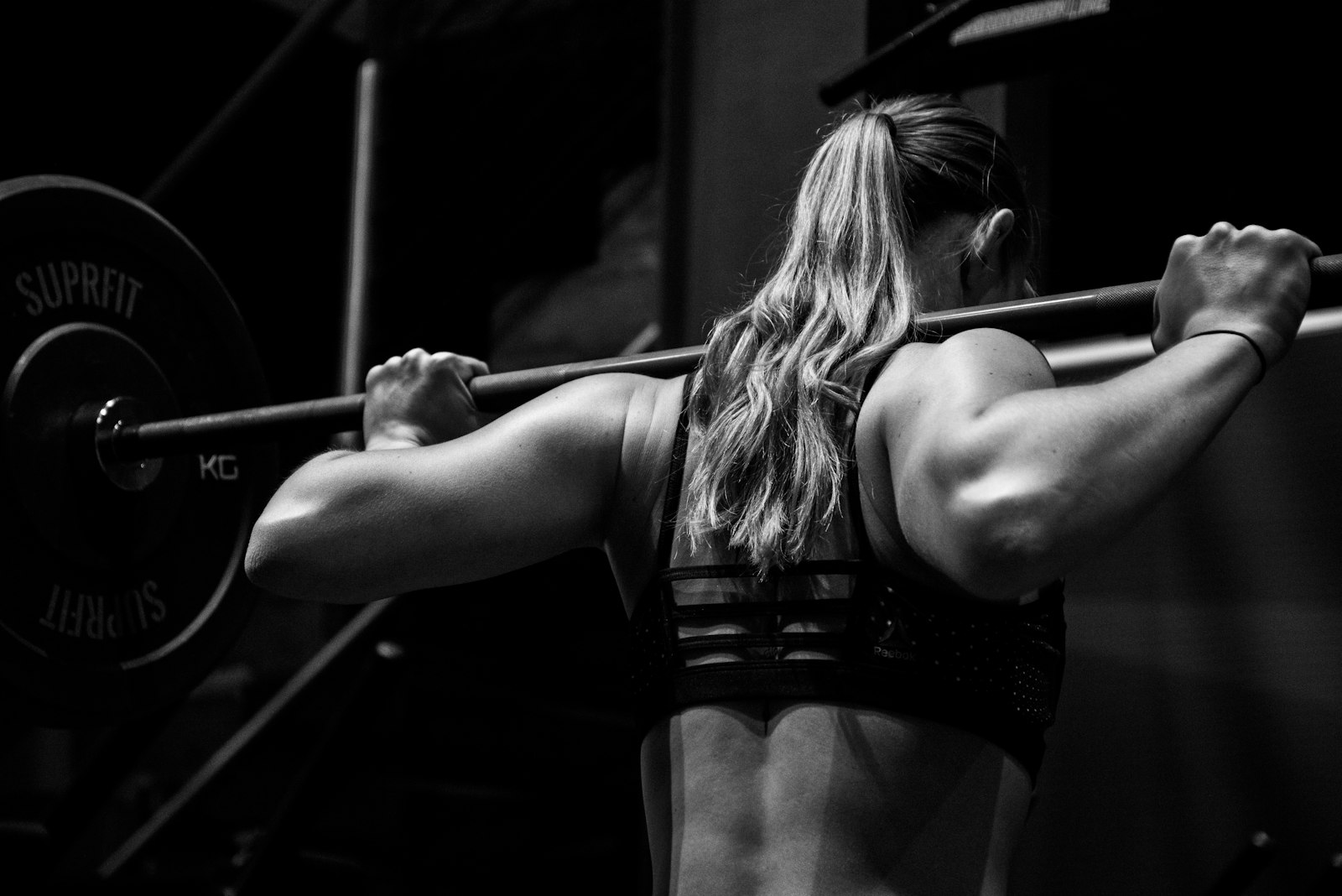 A barbell held across the shoulders during a gym workout
