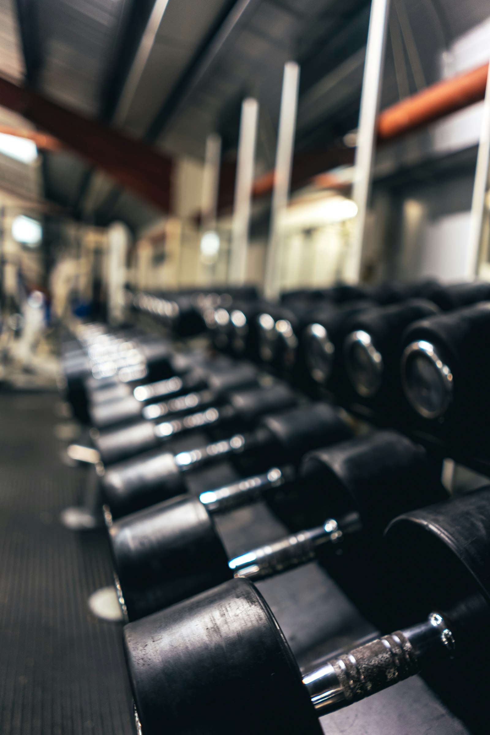 A long row of dumbbells in a gym